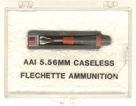 Lot 1 - Clear plastic small display box with AAI 5.56mm caseless cartridge, factory sectioned. 2 x 3 inches. HWS Vol. III, page 355-356, Fig. 468. Ex-Woodin collection. $85-135