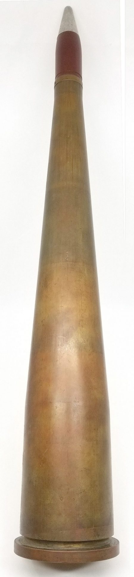 Lot 47 - Experimental 40mm/20mm experimental very high velocity cartridge. Dummy, with struck small copper percussion primer. 40mm brass case, headstamp; “40 MM MK2 TM 8 1944 GMS LOT 6,” screw-in primer. Long case (12.25”/31cm) tapered down to 20mm. Bullet rotating band marked; “*H/M A 20-MM MK13-OD 5-1*.” Projectile is purple/red with plain aluminum fuze. OAL 15.15”/38.4cm. Ex-Woodin collection. $500-750
