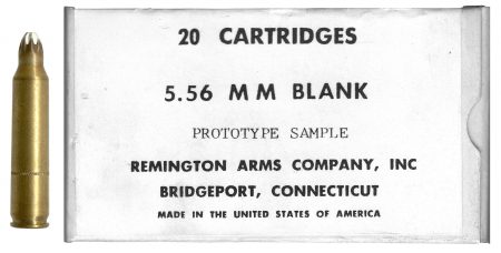 Lot 6 - 20-round box; “5.56 MM BLANK, PROTOTYPE SAMPLE, etc.” Remington. Contains three 5.56mm blanks, “R A 6 5” with red PA, 7-petal rose crip mouth with white tip, knurled cannelure 0.5 inch up from base. Ex-Woodin collection. $50-65