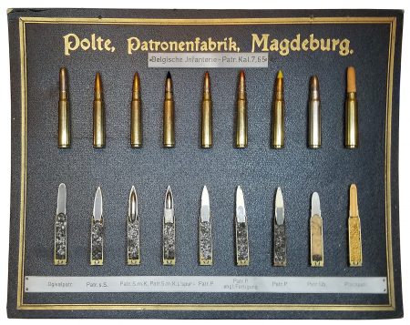 Lot 68 - Polte, Patronenfabrik, Magdeburg display board. “Belgische Jnfanterie-Patr. Kal. 7,65.” 9 different 7.65mm rifle cartridges, whole and sectioned. Beautiful condition with slight cardboard warping. Mixed headstamps from early 1930s. 29.6 x 38.2cm. Ex-Woodin collection. $1,250- 1,500