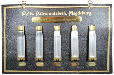 Lot 9 - Polte, Patronenfabrik Magdeburg display board. “Tuf – Hülsen m. verringertem Laderaaum.” Five different 13.2 x 92SR aluminum- lined cases for reduced powder load. Beautiful condition. 18.4 x 29.7cm. Ex-Woodin collection. $500-850